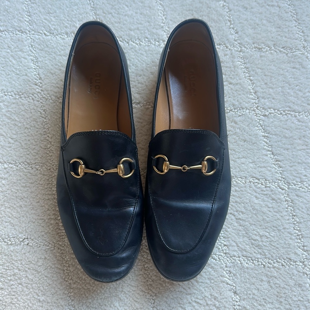Gucci black loafer.  Worn many times.   Both shoes need polished.